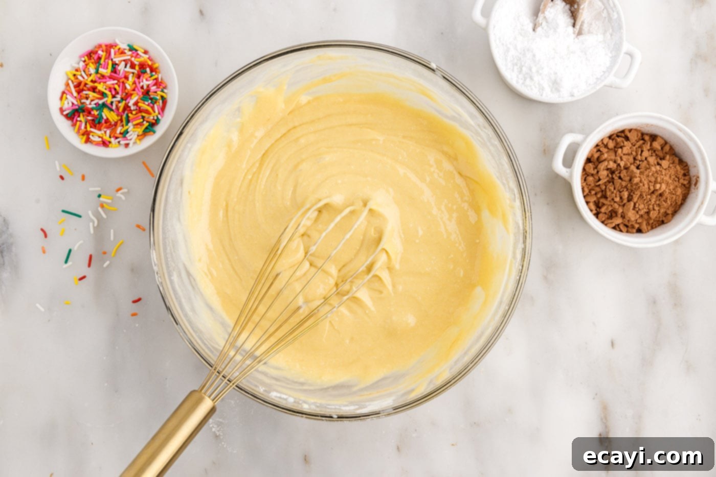 Effortless Cake Mix Donuts 6 whisking together cake mix with eggs, milk, oil, and sour cream