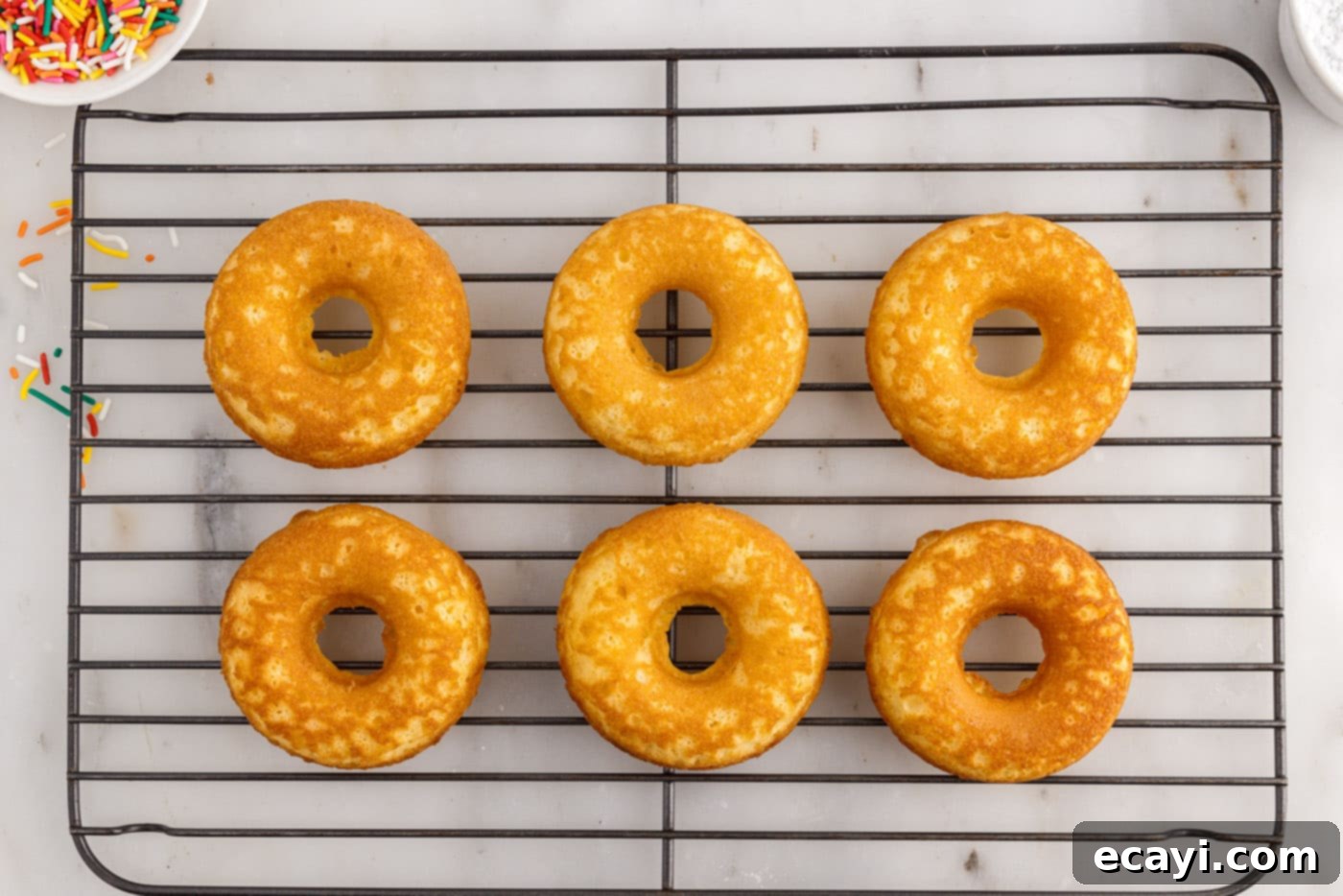 Effortless Cake Mix Donuts 10 donuts cooling on a wire rack