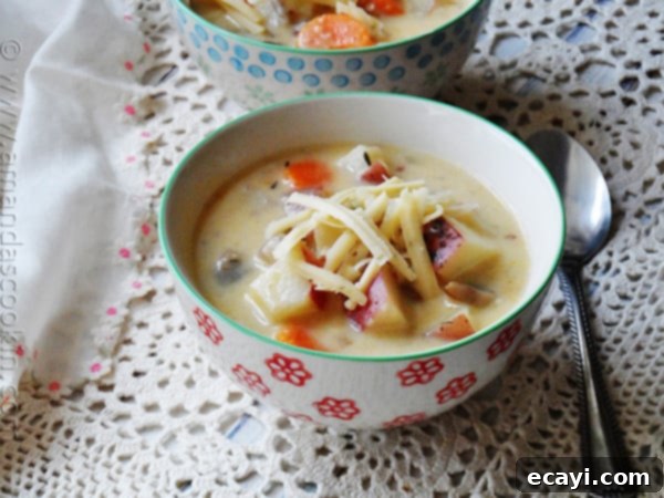 Farmhouse Garlic Potato Comfort Soup 2 A close up photo of rustic garlic potato soup in a bowl.