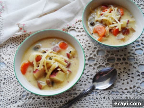 Farmhouse Garlic Potato Comfort Soup 3 A photo of two bowls of rustic garlic potato potato soup.