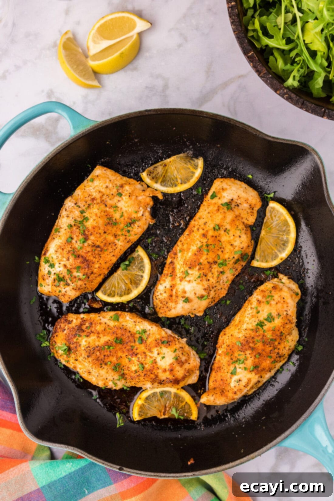 Cajun Spiced Blackened Chicken 2 Blackened Chicken sizzling in a cast iron skillet with fresh lemon slices, showcasing a perfectly seared crust.
