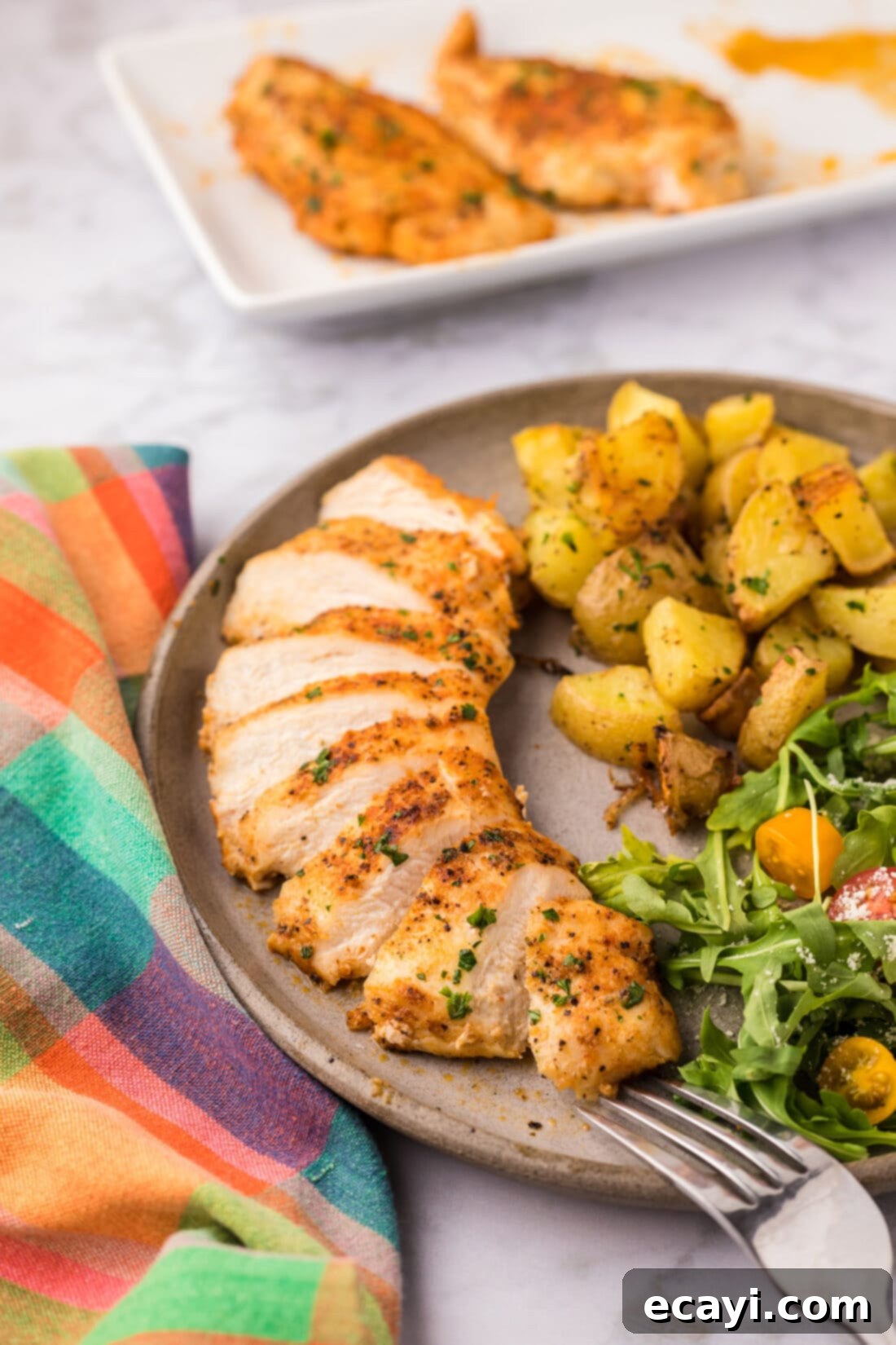 Cajun Spiced Blackened Chicken 11 A plate of perfectly cooked Blackened Chicken, served alongside a fresh green salad and roasted potatoes, creating a balanced and delicious meal.