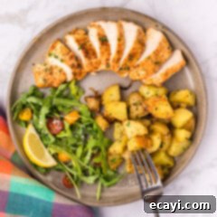 Cajun Spiced Blackened Chicken 12 Overhead photo of Blackened Chicken on a plate with a salad, potatoes and a fork on the side