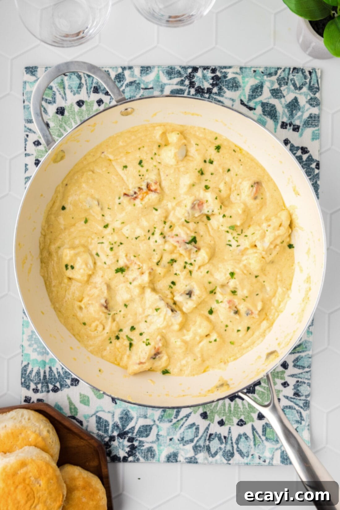 Velvet Lobster Delight 2 A skillet filled with creamy Lobster Newburg, served alongside golden-brown biscuits.