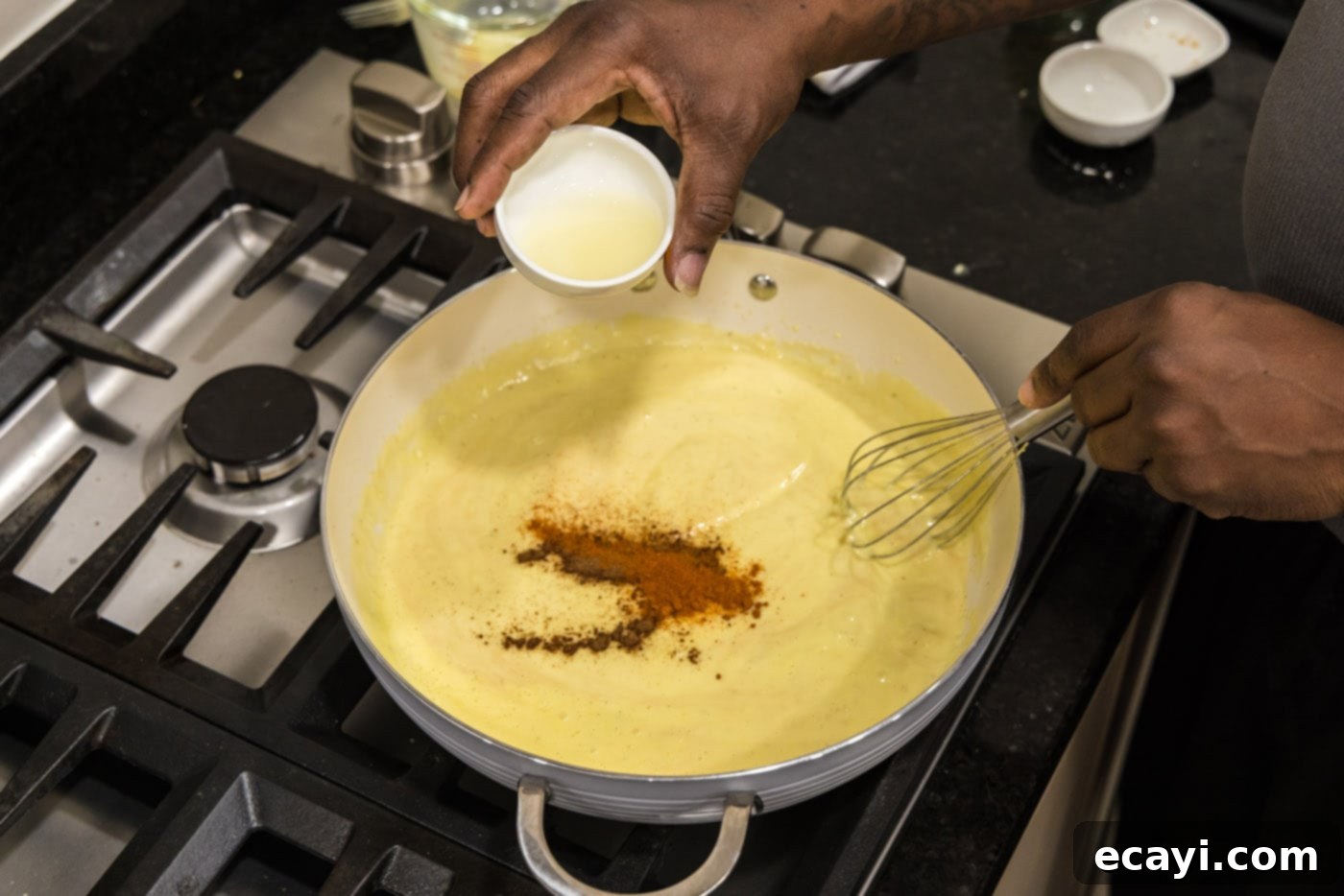Velvet Lobster Delight 14 Squeezing fresh lemon juice into the cream mixture with other seasonings in the skillet.