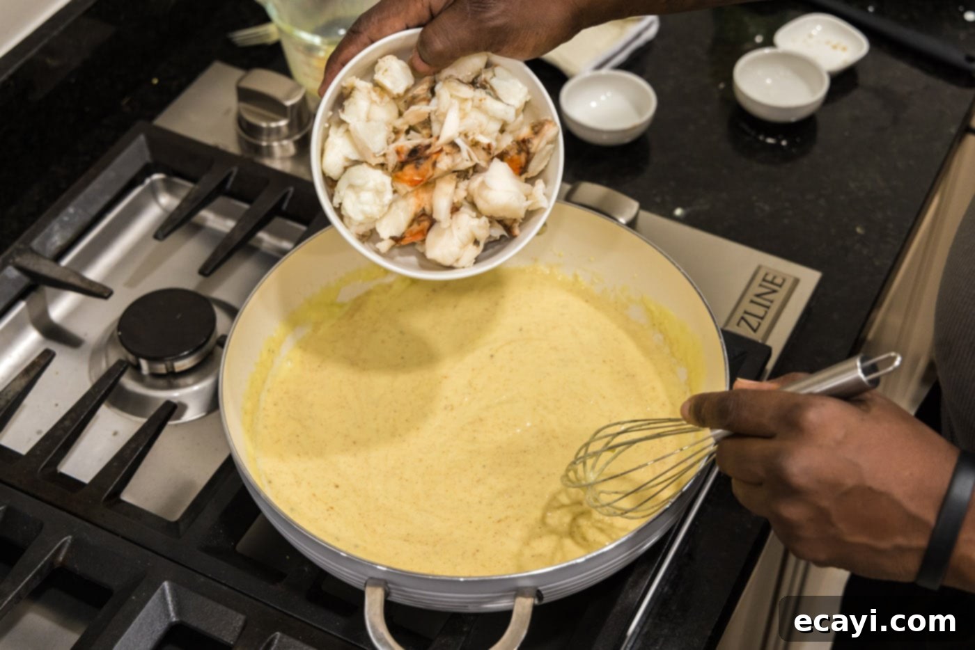 Velvet Lobster Delight 15 Adding cooked lobster chunks into the creamy sauce.