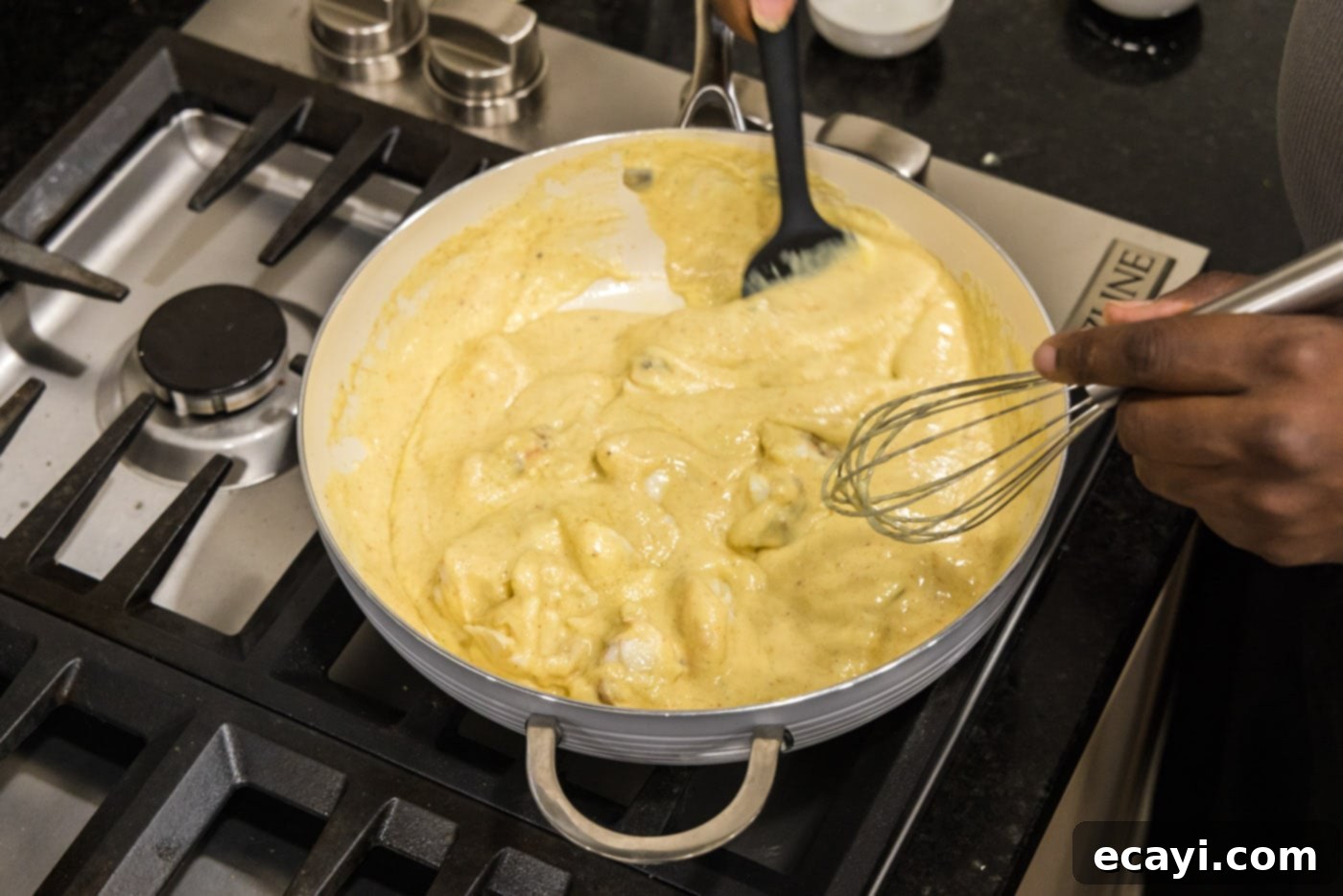 Velvet Lobster Delight 16 Gently mixing the lobster chunks into the cream sauce for Lobster Newburg.