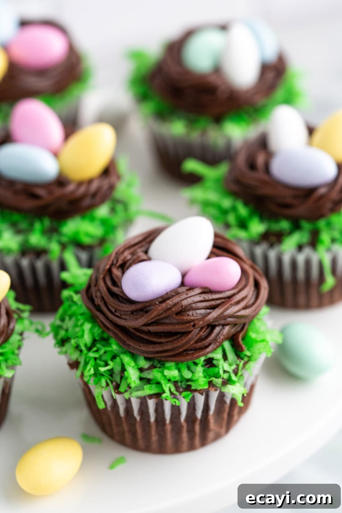 Springtime Nest Delights 2 Close up photo of a Easter Nest Cupcake with more behind it