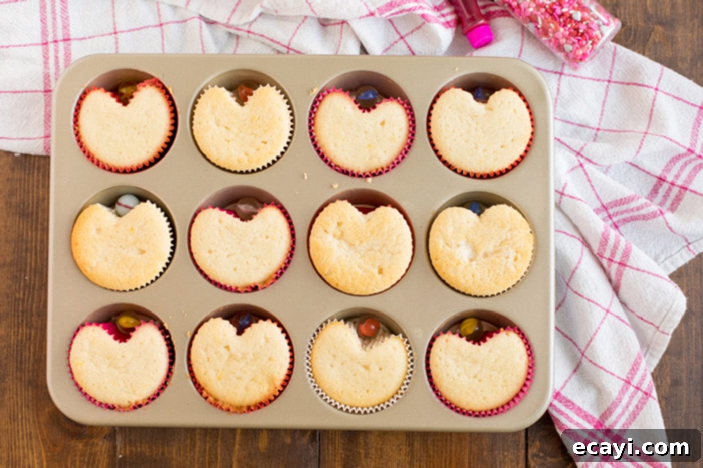 Heartfelt Valentine Cupcakes 9 Baked Valentine Heart Cupcakes still in the muffin pan, showing their fresh-out-of-the-oven appearance.