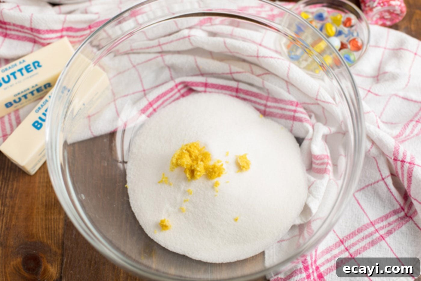 Heartfelt Valentine Cupcakes 5 Sugar and lemon zest in a bowl, demonstrating the first step in creating a fragrant base for the cupcake batter.