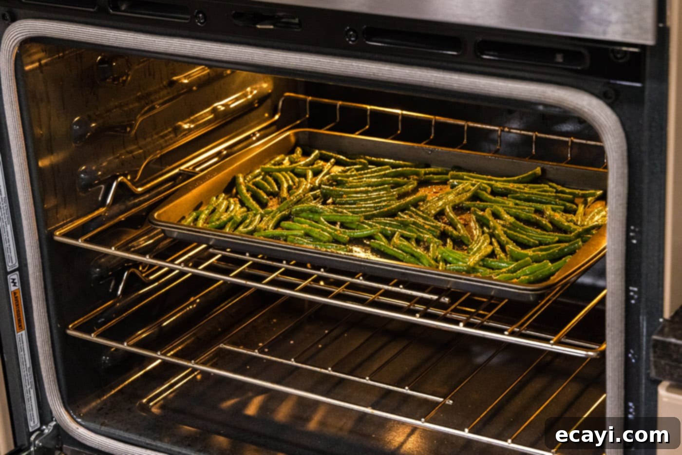 Crispy Roasted Green Beans 10 roasted green beans on a baking sheet, golden and tender, in the oven