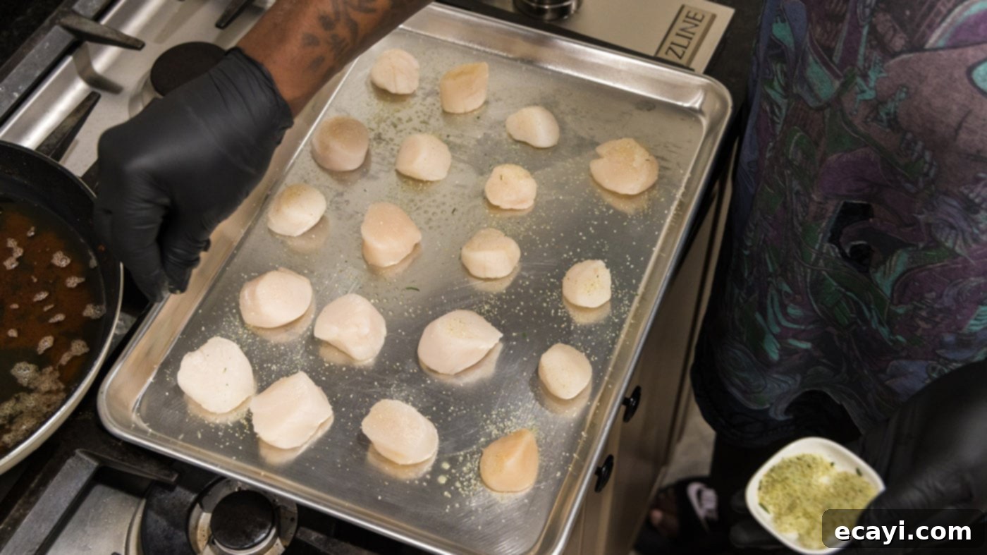 Golden Baked Scallops 5 Fresh scallops arranged on a baking sheet, ready for seasoning.