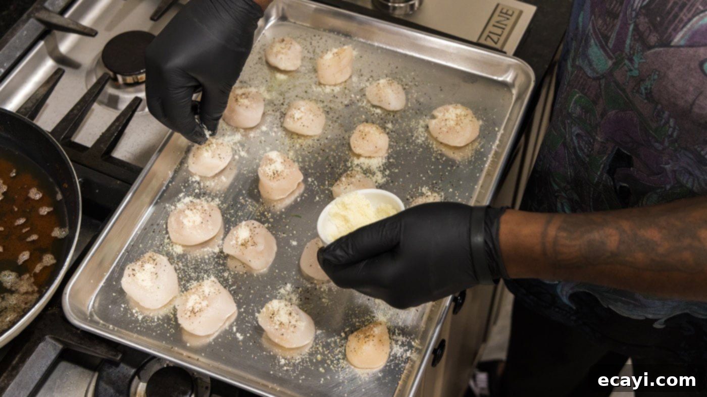 Golden Baked Scallops 8 Adding grated Parmesan cheese over the breadcrumbs on the scallops.