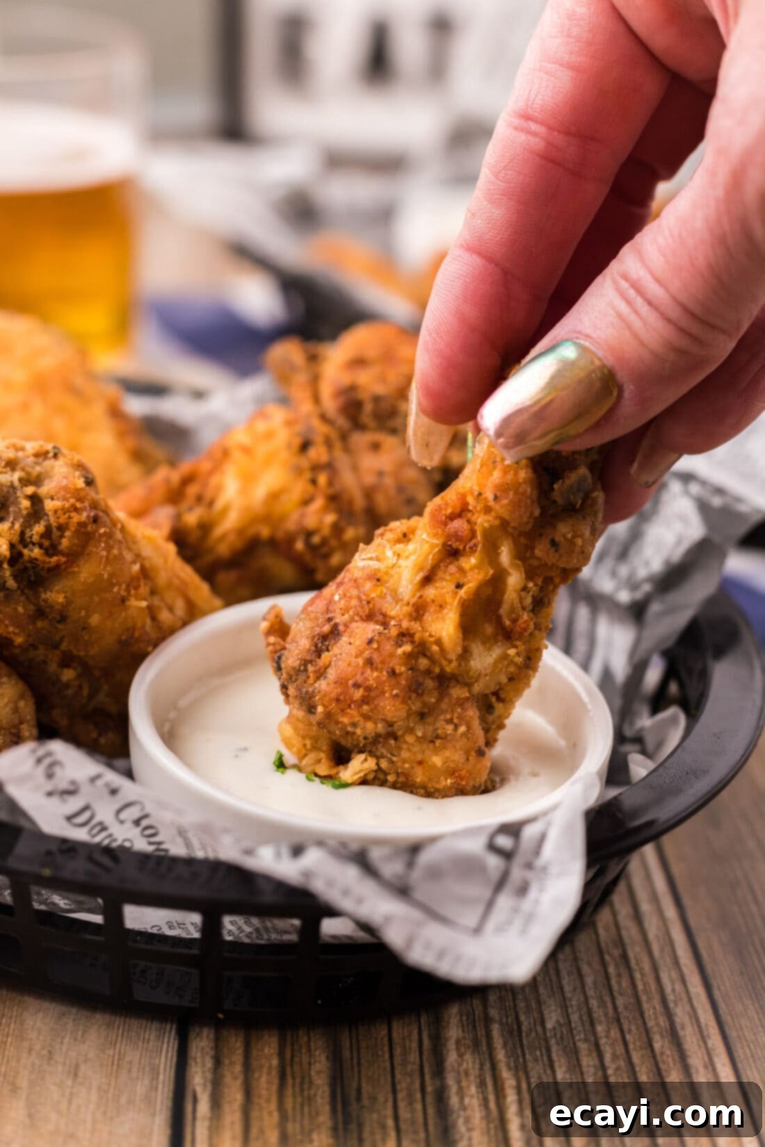 Crispy Fried Chicken Wings 3 A Fried Chicken Wing being dipped into a bowl of creamy ranch dressing, highlighting its golden crispness.