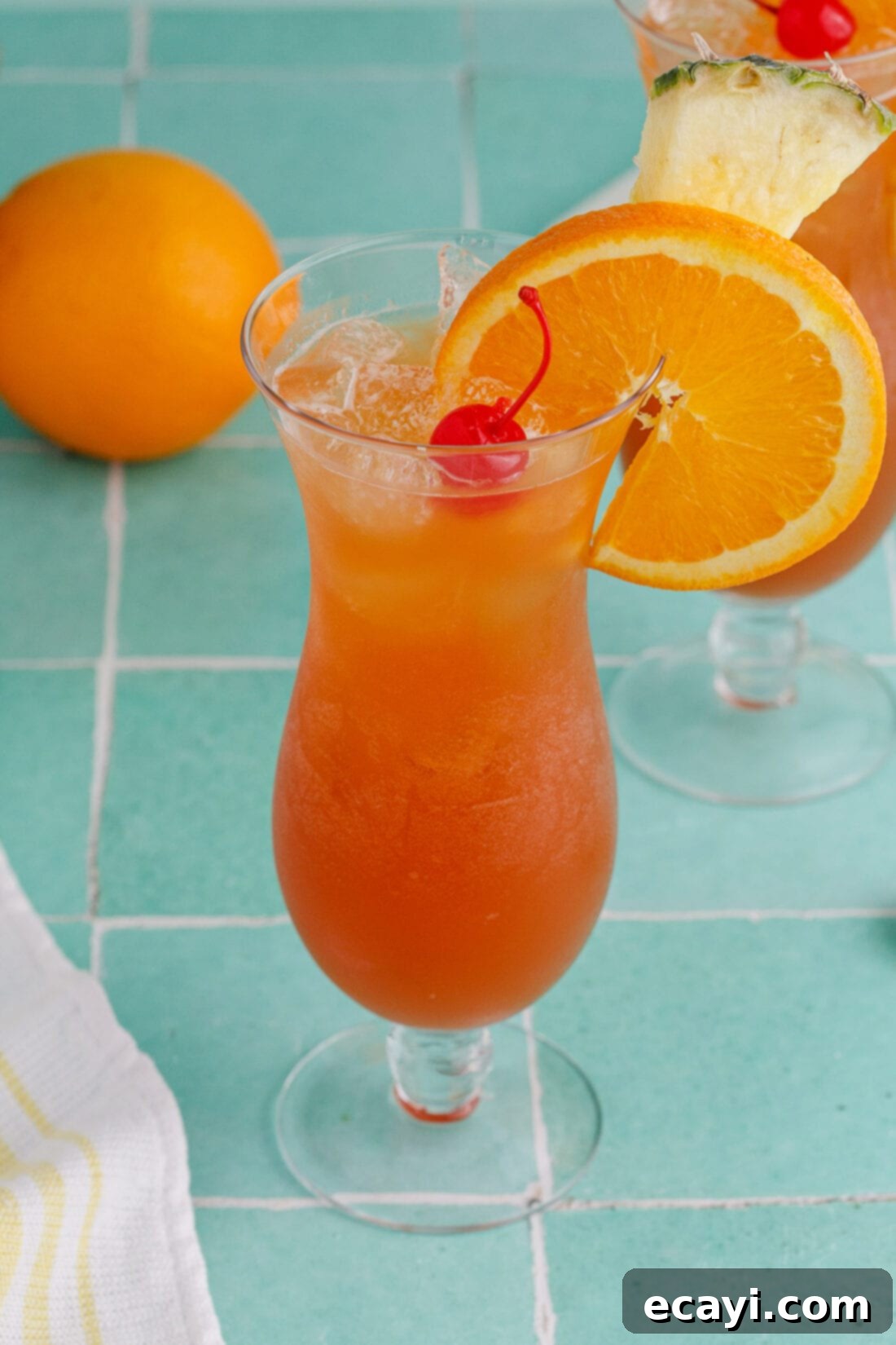 Whiskey Wake 2 Rum Runner garnished with an orange wheel, pineapple wedge and cherry