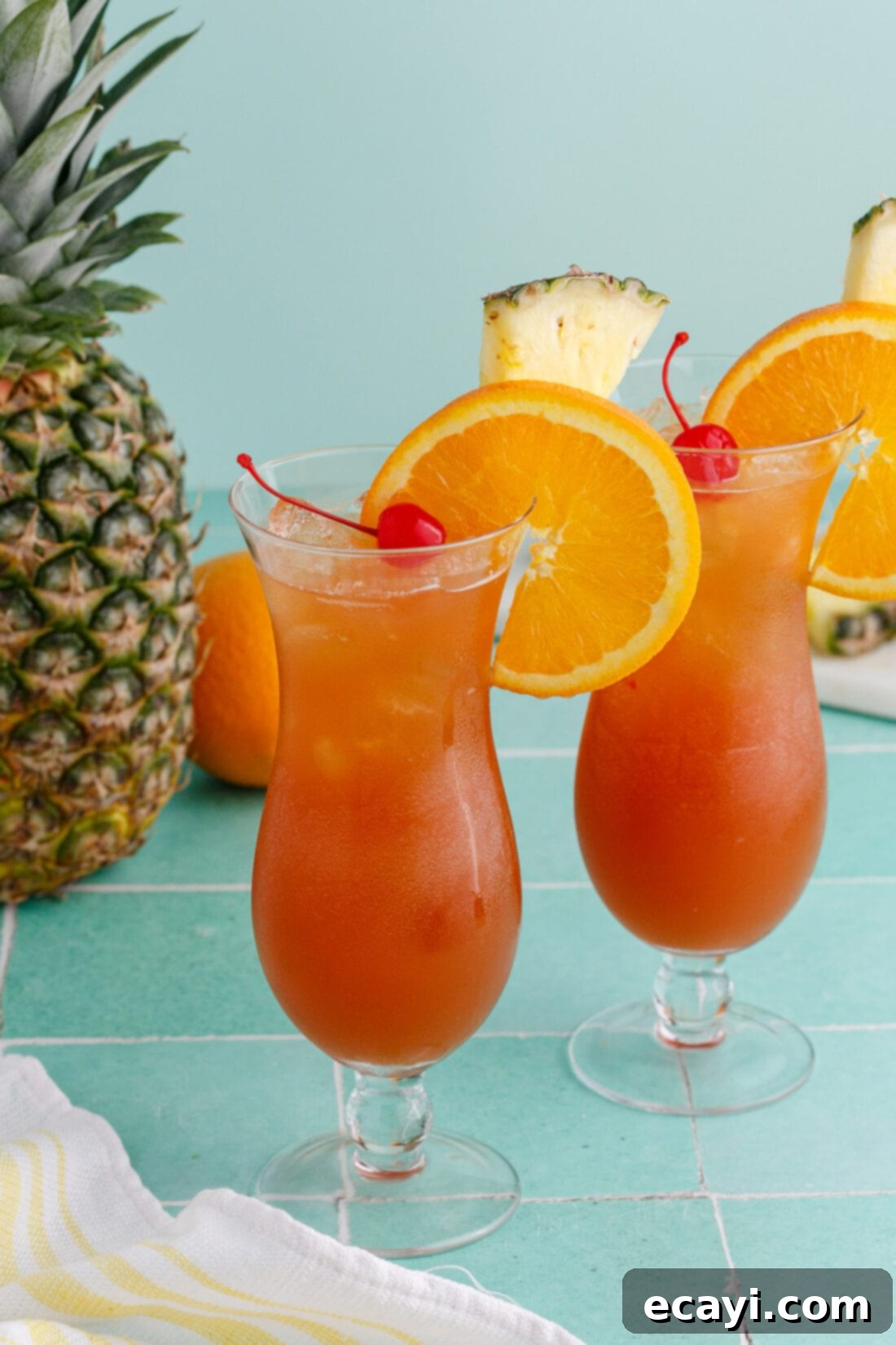 Whiskey Wake 4 Two Rum Runners garnished with an orange wheel, pineapple wedge and cherry