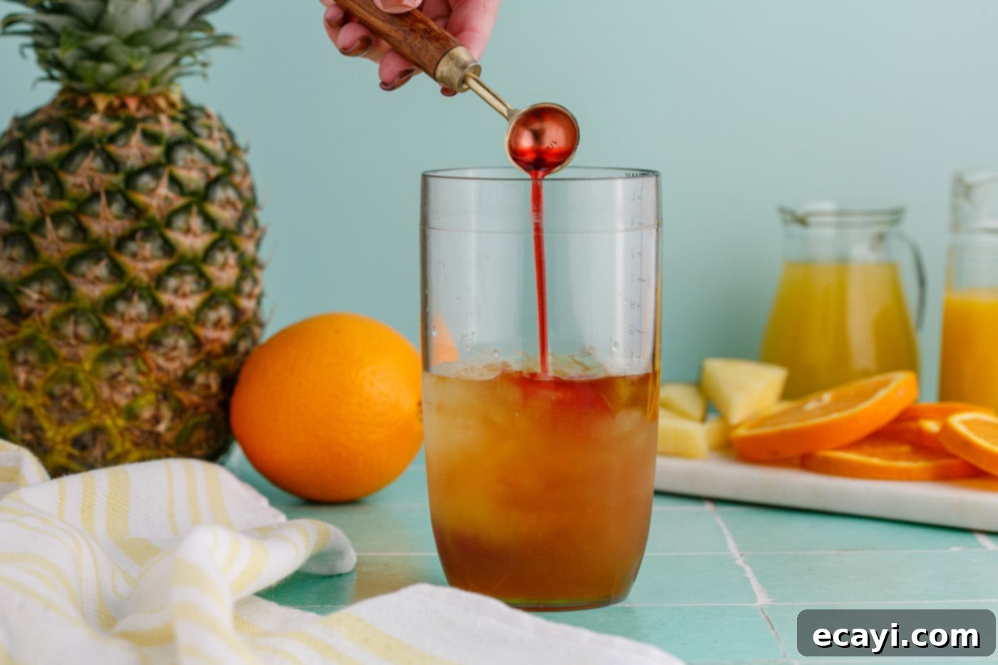 Whiskey Wake 6 adding grenadine to cocktail glass with rum and liqueur