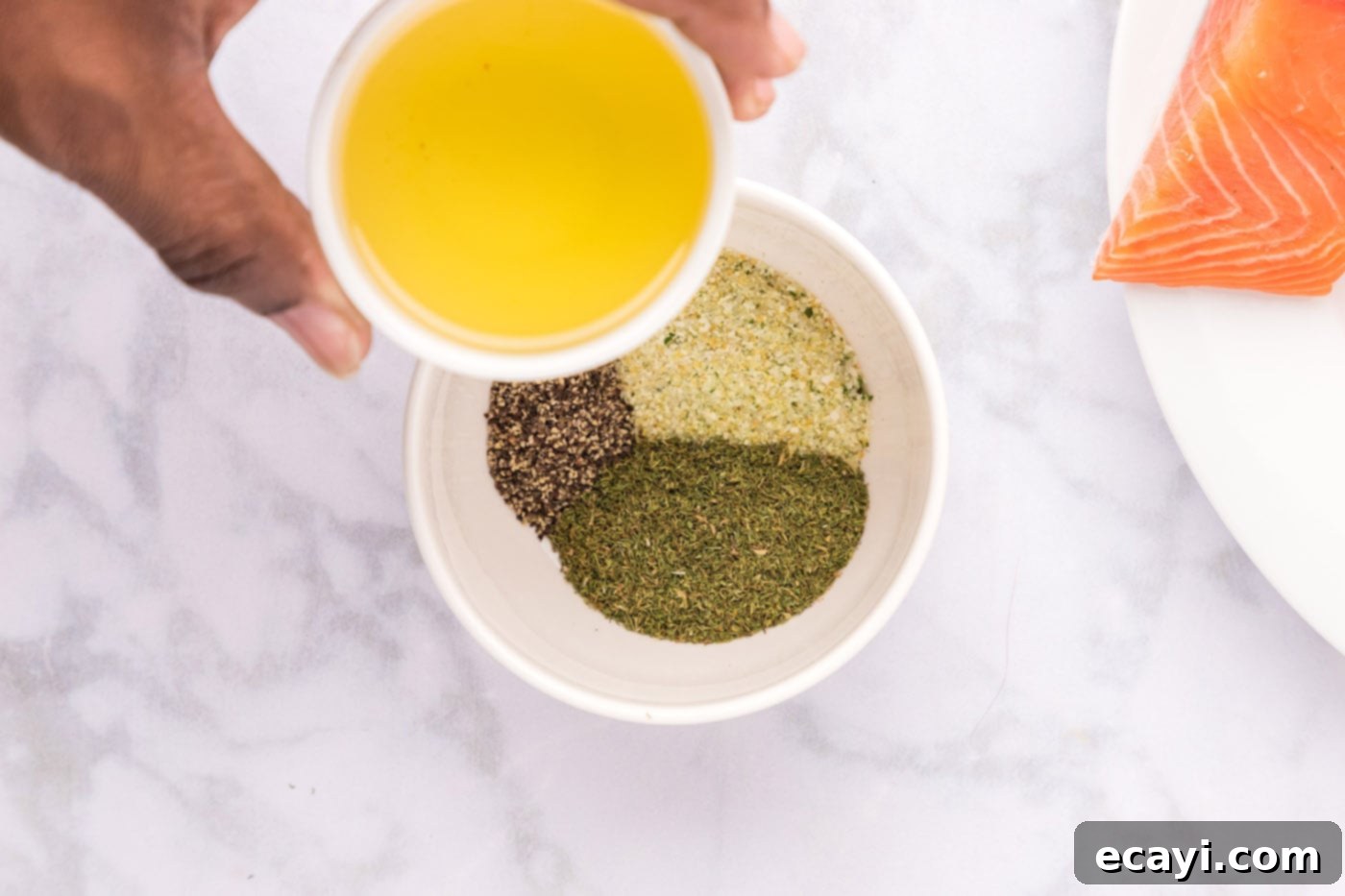 Zesty Dill Salmon 5 olive oil over a bowl of seasonings
