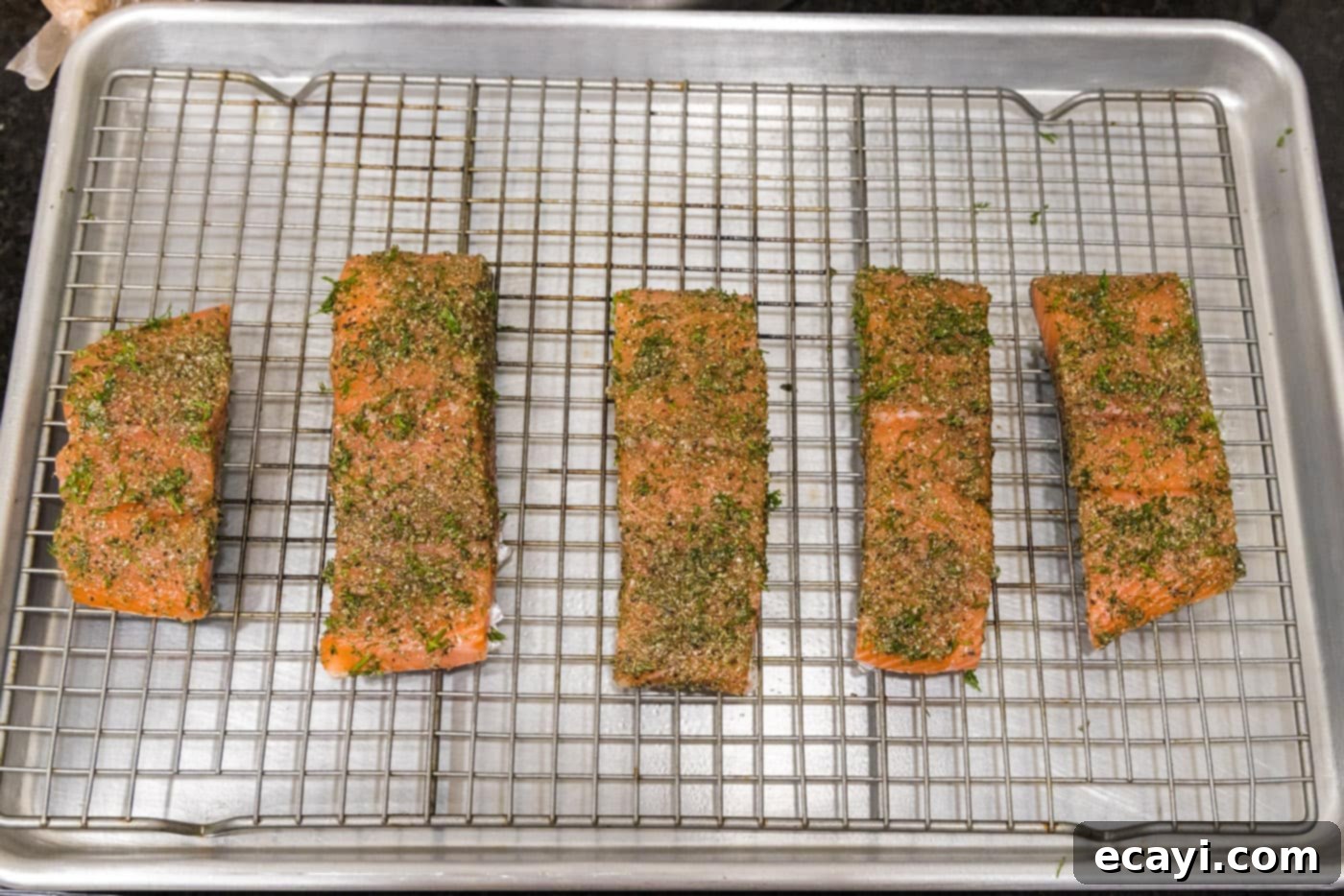 Zesty Dill Salmon 7 dill salmon filets on a baking sheet with a wire rack