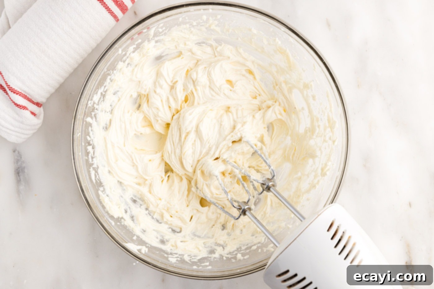 Swirled Carrot Delight 14 Creamy and fluffy cream cheese filling in the bowl of an electric mixer.