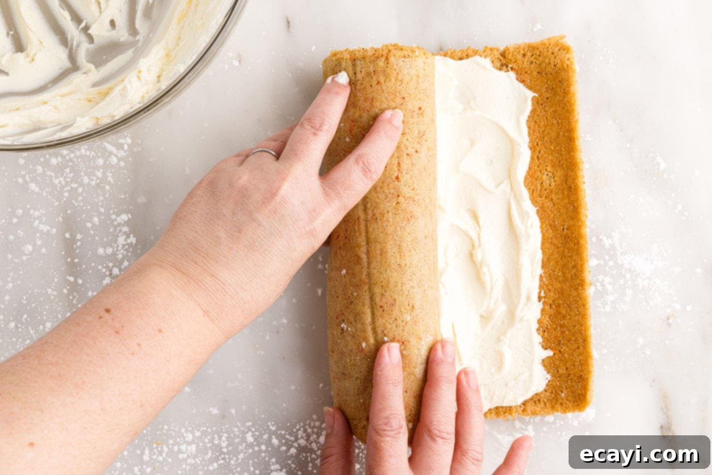 Swirled Carrot Delight 18 Re-rolling the carrot cake log with the cream cheese filling tucked inside, creating the spiral.