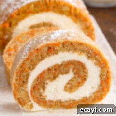 Swirled Carrot Delight 21 Close up photo of a Carrot Cake Roll slice with cream cheese frosting