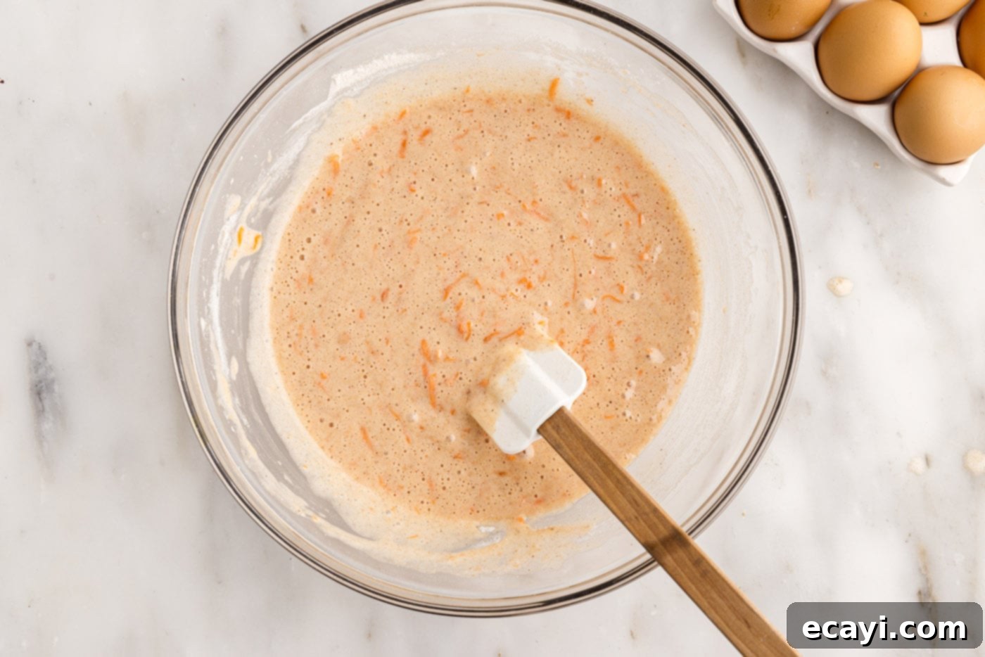 Swirled Carrot Delight 8 Smooth, spiced carrot cake batter in a mixing bowl, ready for baking.