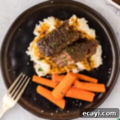 Tender Boneless Beef Short Ribs 13 Overhead photo of Boneless Beef Short Ribs served on mashed potatoes with carrots on the side