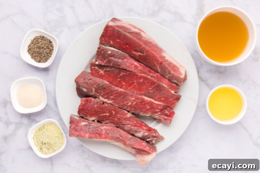 Tender Boneless Beef Short Ribs 4 A selection of fresh ingredients laid out on a kitchen counter, including boneless beef short ribs, seasonings, olive oil, and chicken broth, ready for cooking.