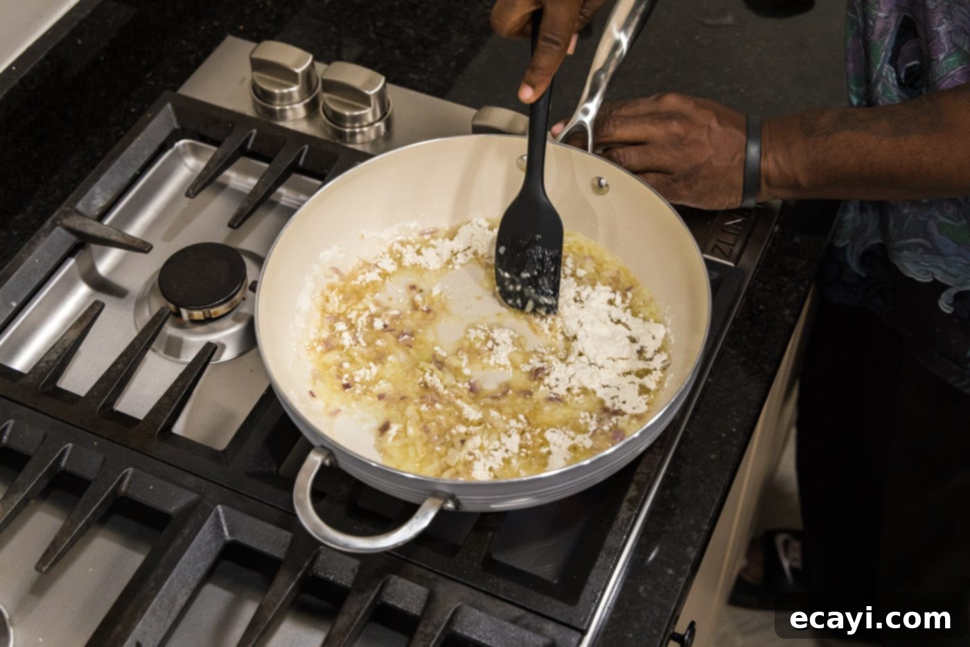 Crawfish Etouffee: A Taste of Louisiana 7 spatula stirring roux in a skillet