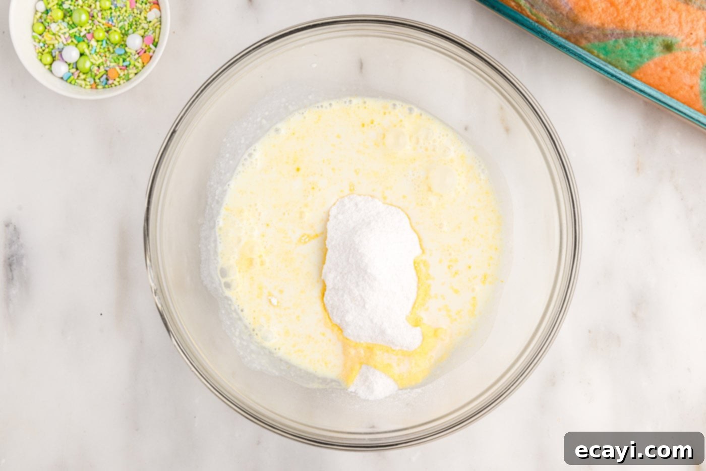 Springtime Poke Cake Delight 13 instant vanilla pudding with milk in a bowl