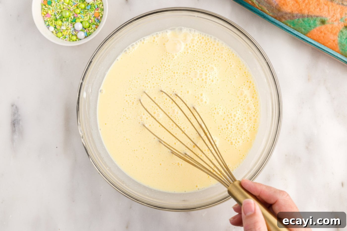Springtime Poke Cake Delight 14 whisking instant vanilla pudding in a bowl