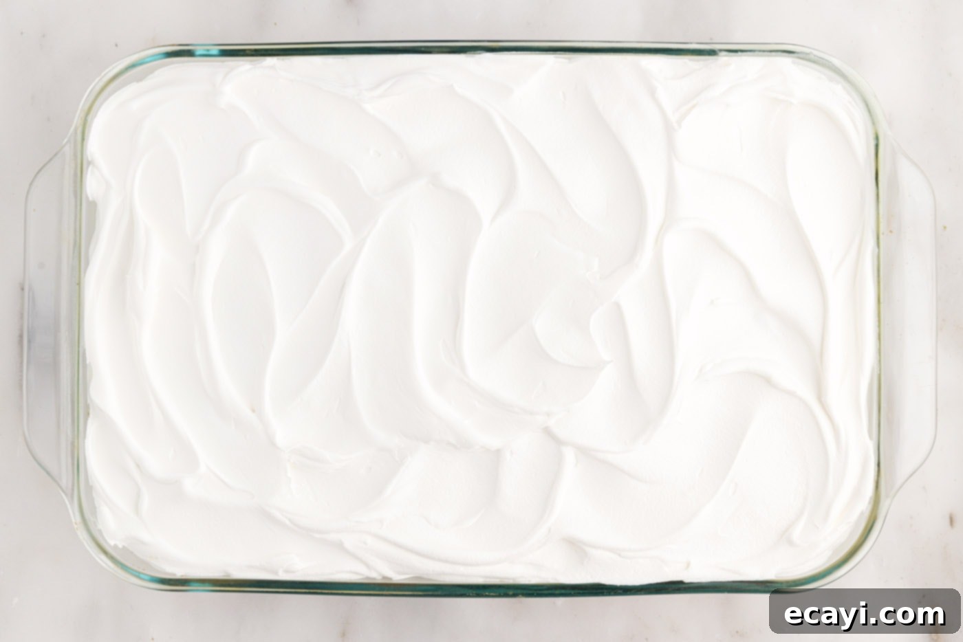 Springtime Poke Cake Delight 18 swirled cool whip on top of cake