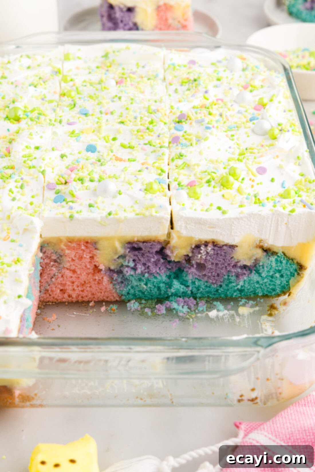 Springtime Poke Cake Delight 3 Easter Poke Cake in a 13x9 baking dish with two pieces removed