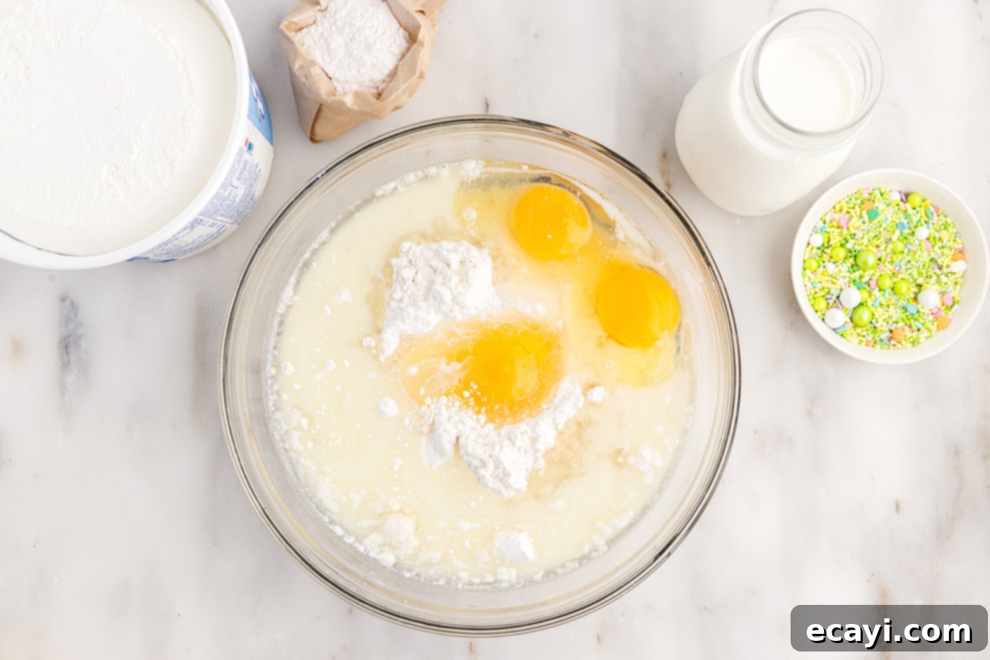 Springtime Poke Cake Delight 5 eggs, oil, milk, and cake mix in a bowl