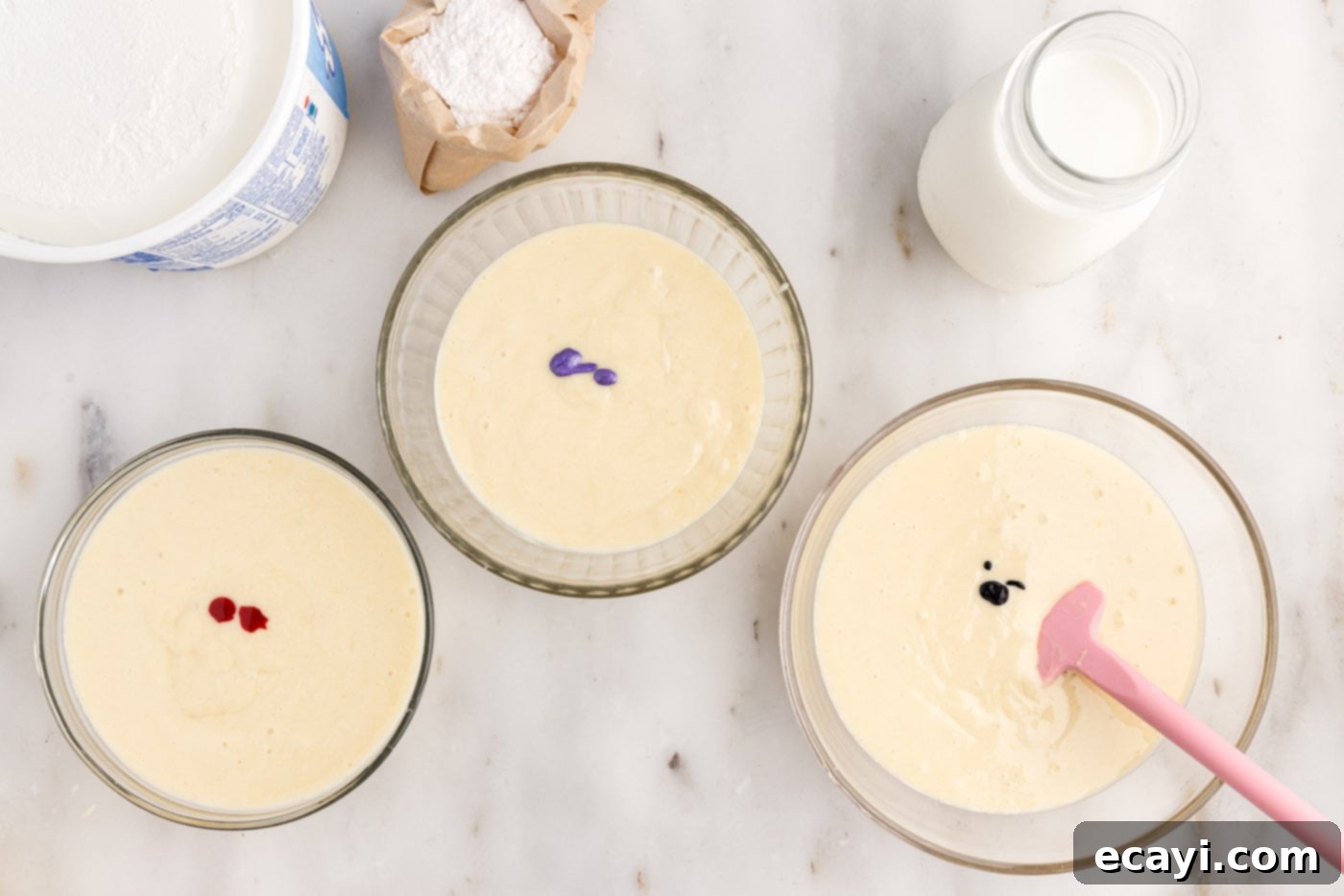 Springtime Poke Cake Delight 7 gel food coloring adding to bowls of cake batter