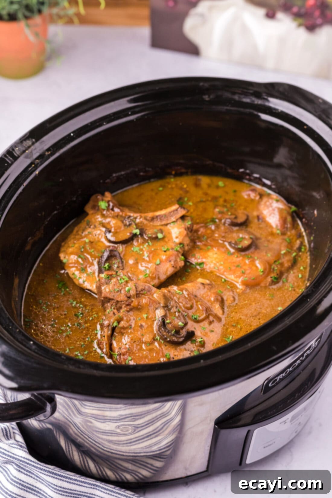 Fall-Off-The-Bone Pork Chops 2 Photo of Crockpot Pork Chops in a brown gravy with mushrooms and onions
