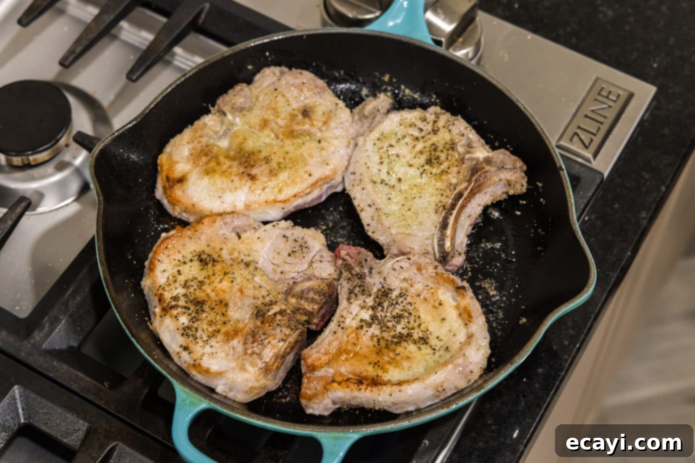Fall-Off-The-Bone Pork Chops 7 Seared pork chops resting in a skillet after browning