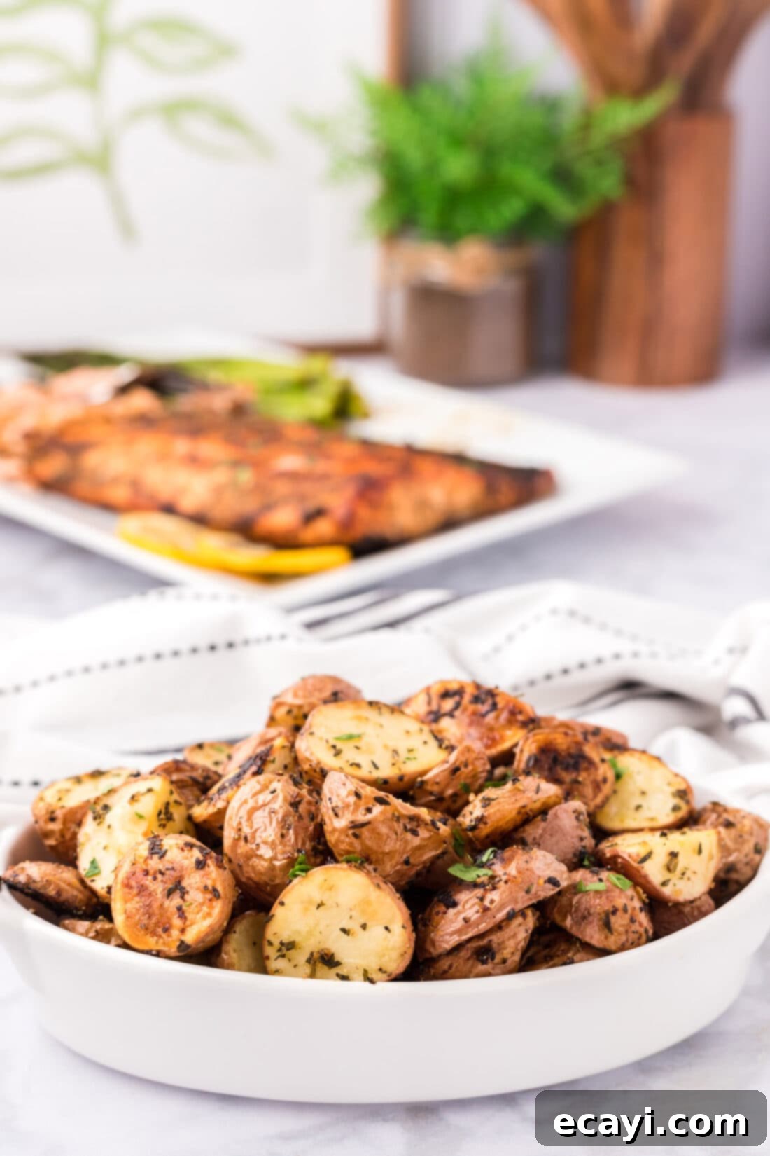 Crispy Roasted Red Potato Medley 2 Roasted Red Potatoes in a serving dish, golden brown and crispy, garnished with fresh herbs