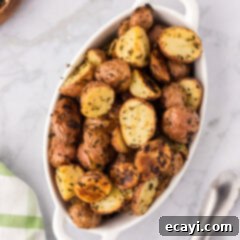 Crispy Roasted Red Potato Medley 12 Overhead photo of Roasted Red Potatoes in a serving dish, perfectly golden and garnished