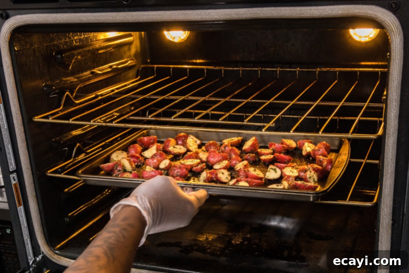 Crispy Roasted Red Potato Medley 9 red potatoes roasting on a baking sheet in the oven, turning golden