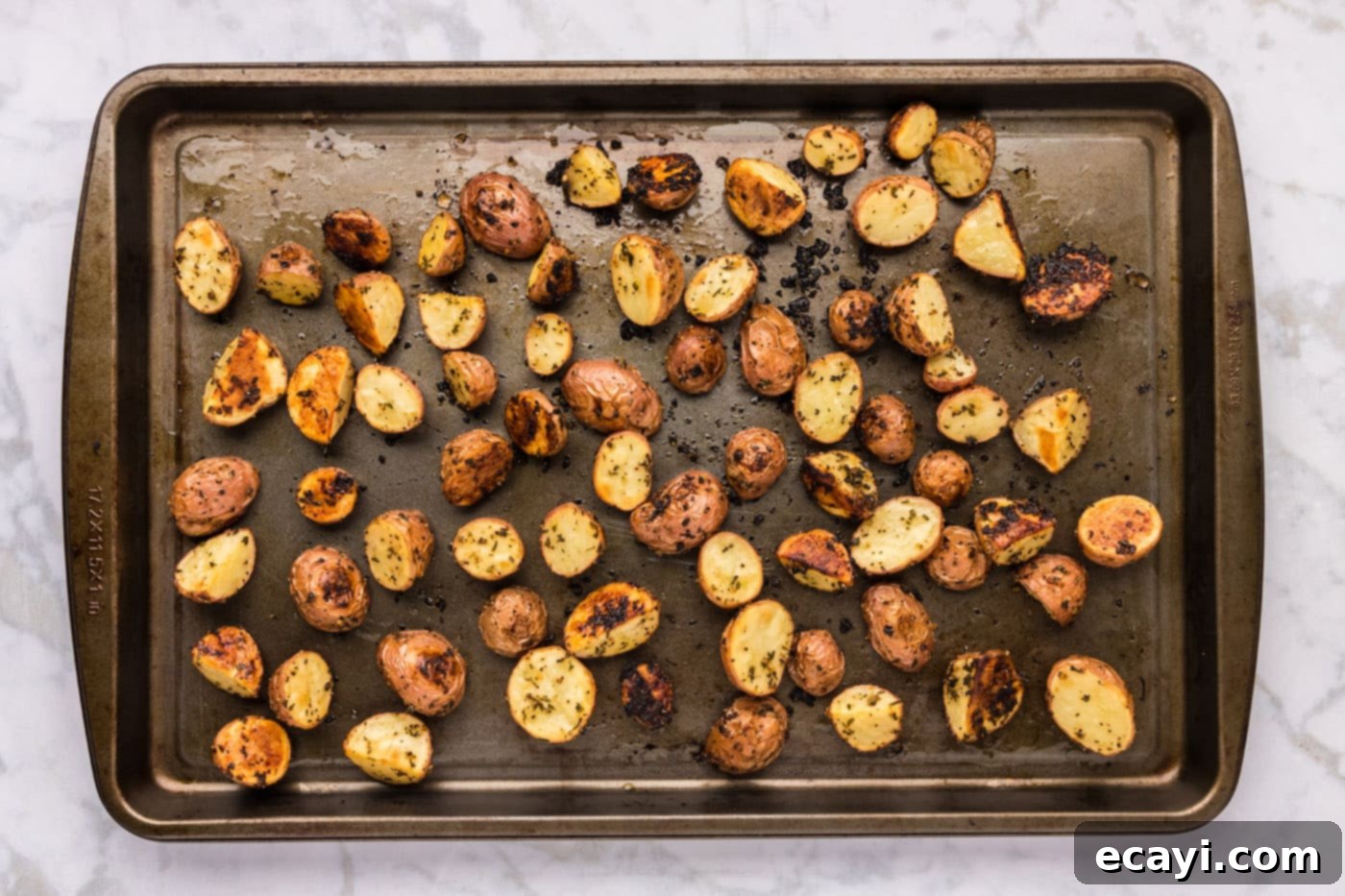 Crispy Roasted Red Potato Medley 10 overhead shot of golden roasted red potatoes on a baking sheet, fresh out of the oven, perfectly crisp