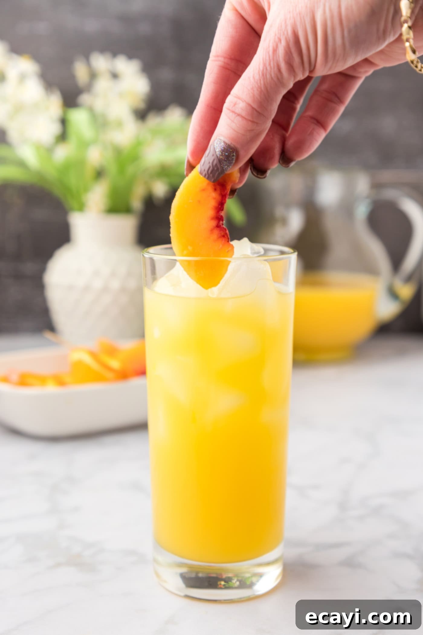 Golden Peach Nectar 9 adding frozen peach slices to fuzzy navel cocktail