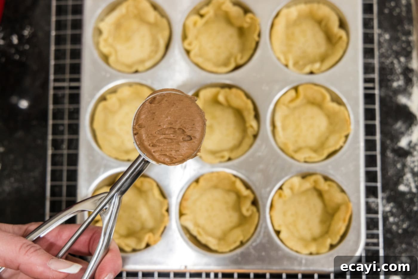 Petite French Silk Pies 25 scooping french silk filling into mini pie crusts