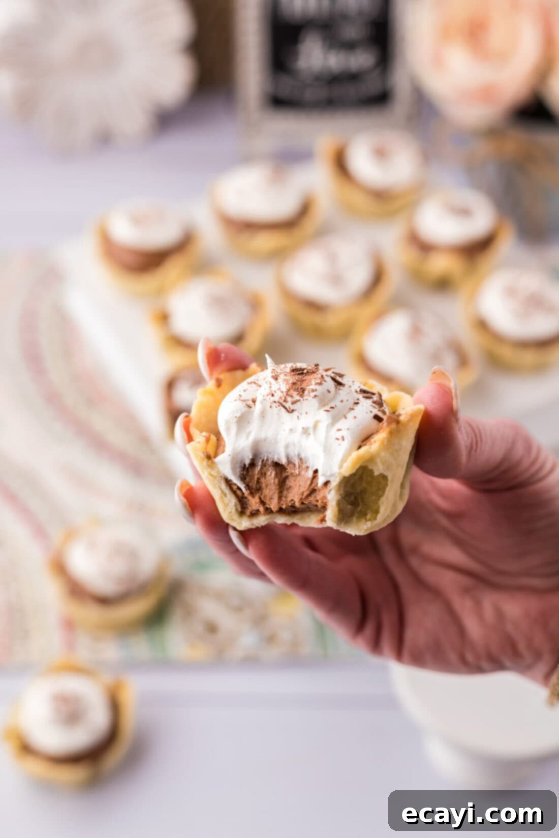 Petite French Silk Pies 30 Hand holding a Mini French Silk Pie with a bite taken out