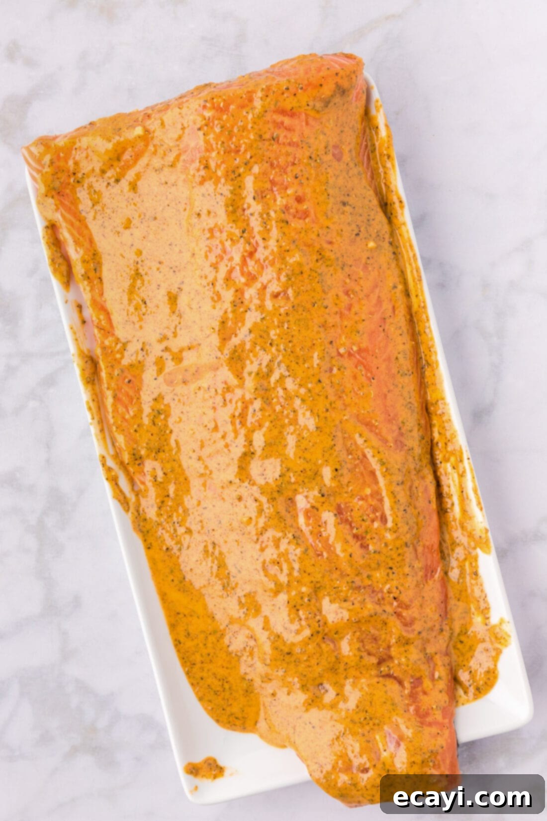 Exquisite Salmon Marinade 2 Salmon Marinade spread on salmon on a serving tray