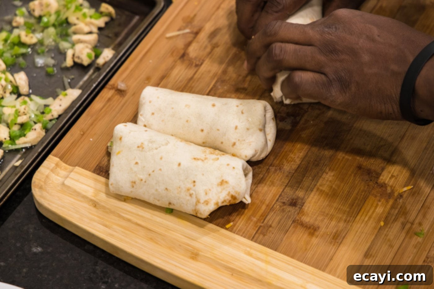 Chimichanga Perfection 17 Several neatly rolled chimichangas arranged on a wooden cutting board, ready for deep-frying