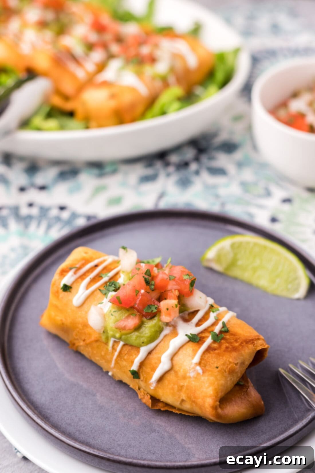 Chimichanga Perfection 3 Golden brown chicken chimichanga on a plate with a fresh lime wedge