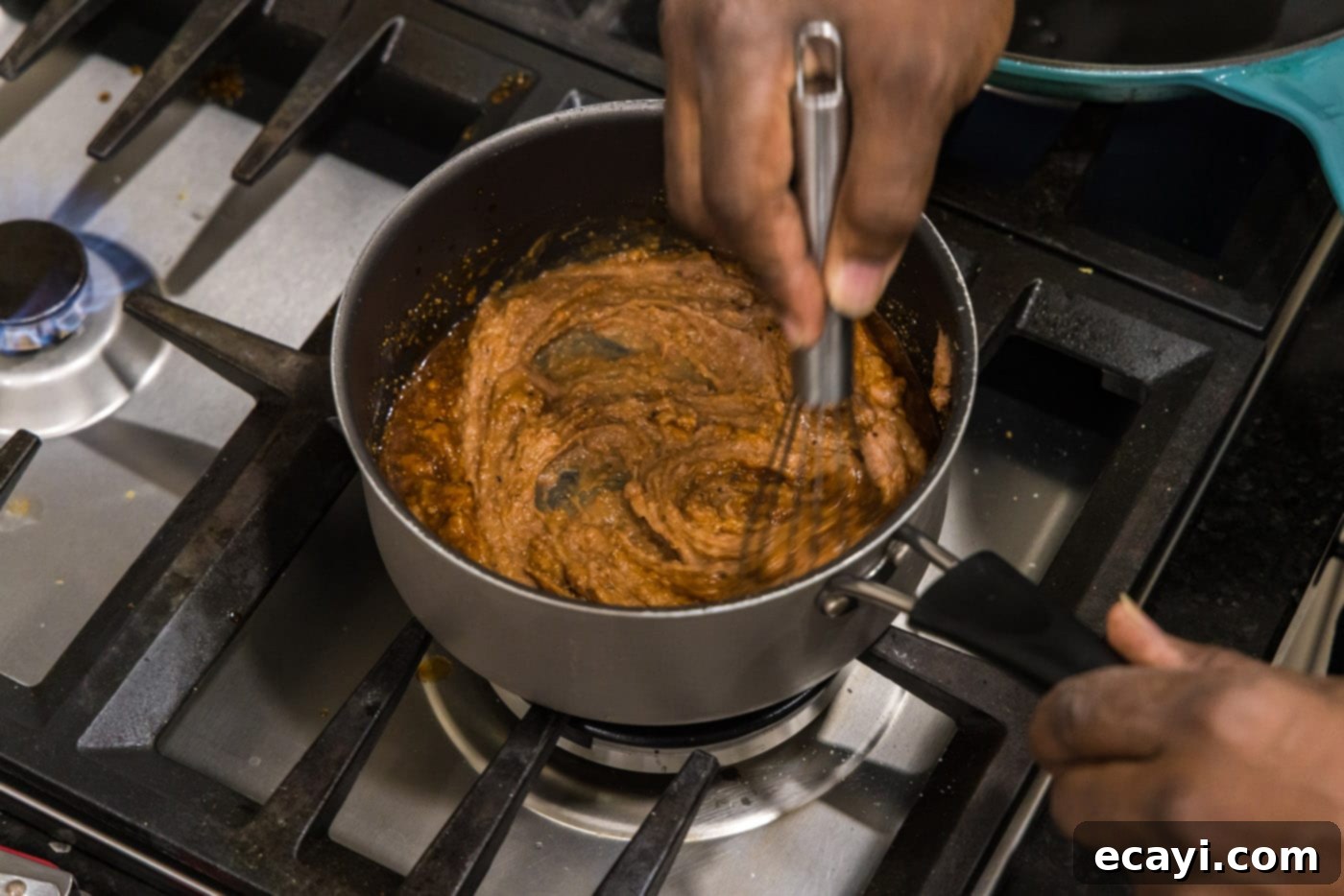 Chimichanga Perfection 7 Whisking refried beans in a pot until smooth and warm for chimichanga filling