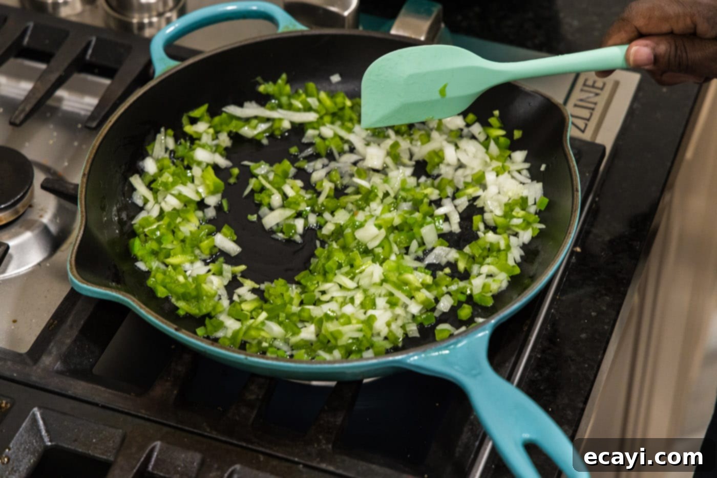 Chimichanga Perfection 8 Chopped green bell pepper and onion sautéing in olive oil in a large skillet for chimichanga filling